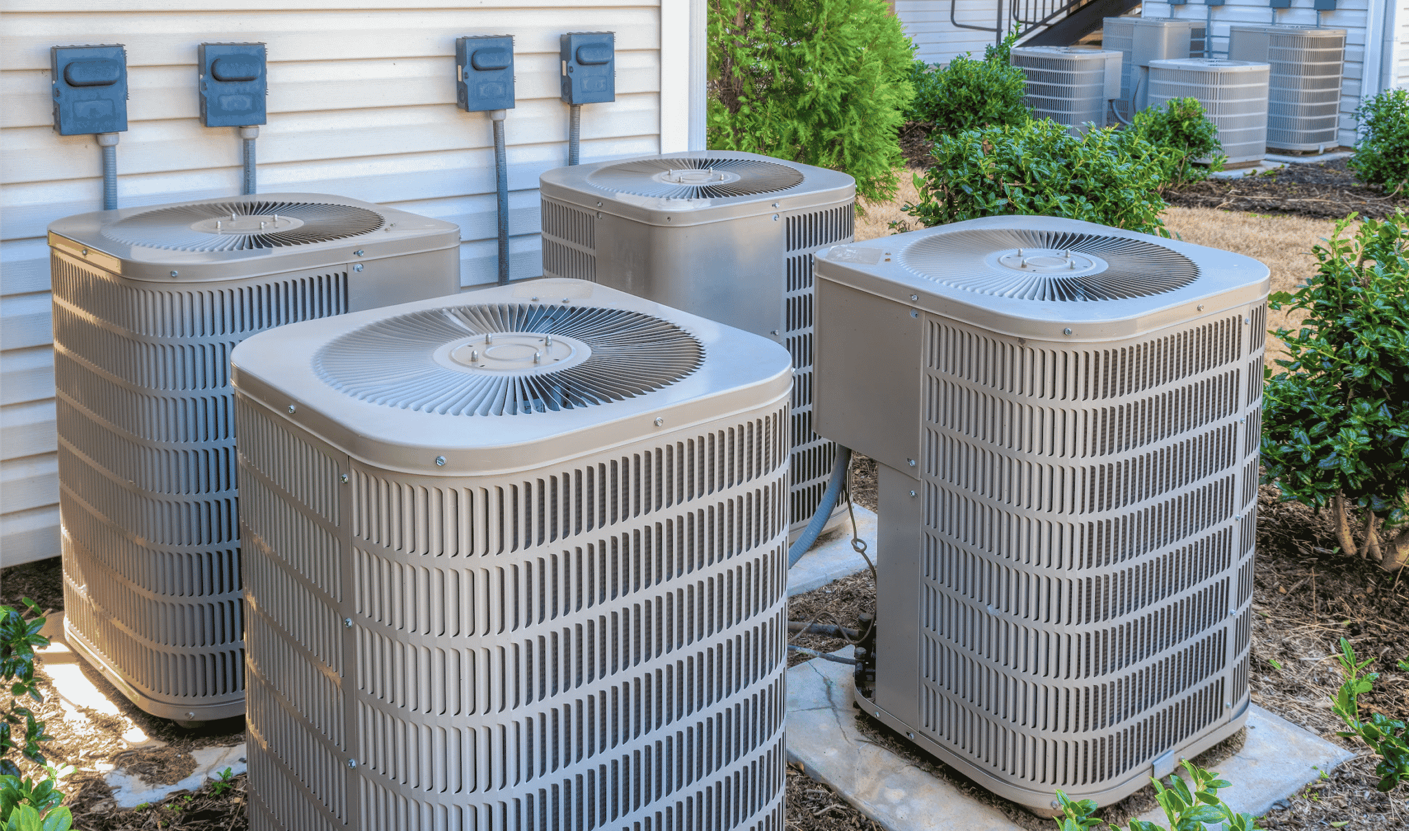 Technician diagnosing failed air conditioner during hot afternoon at Hall County home