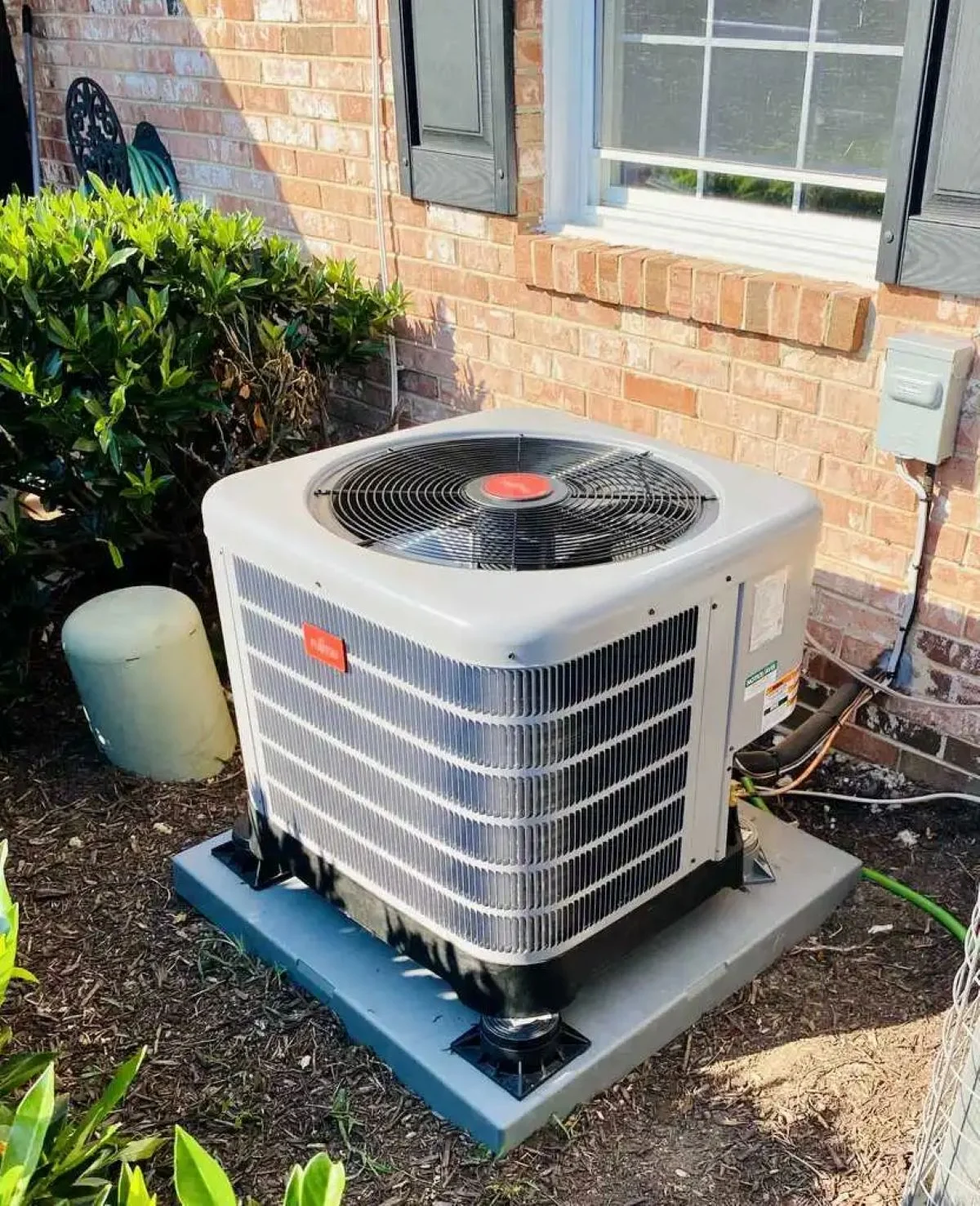 Technician measuring airflow and system fit before full residential HVAC replacement